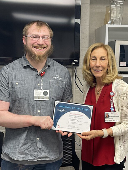 Rob Schilling and Kathleen Rhine hold the employee of the month certificate