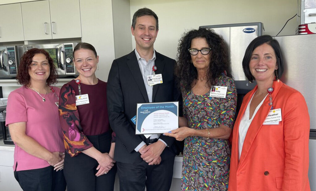 Vicky Lumpkin poses for a photo with her coworkers