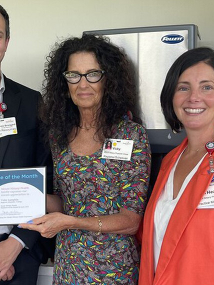 Vicky Lumpkin poses for a photo with her coworkers