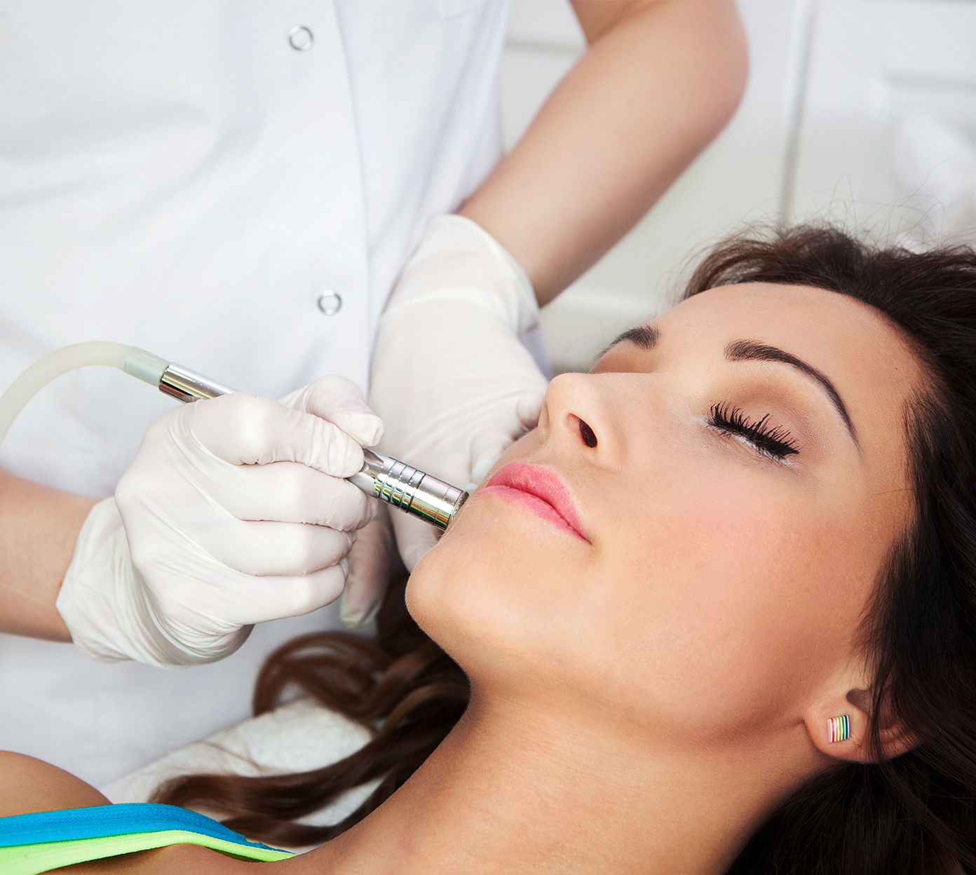 close up of woman's face receiving treatment from a medical professional at a med spa