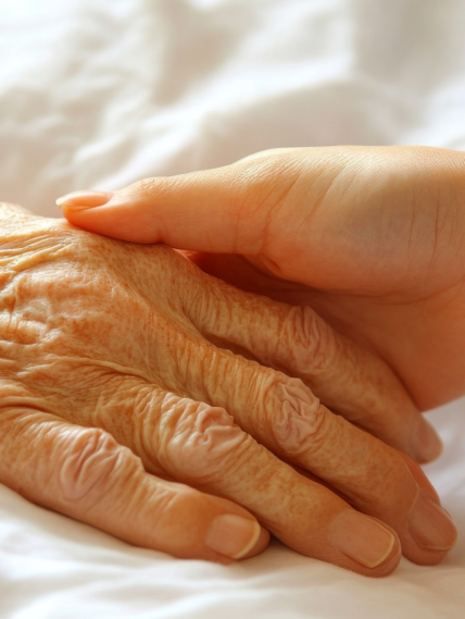 Young hand holding older hand