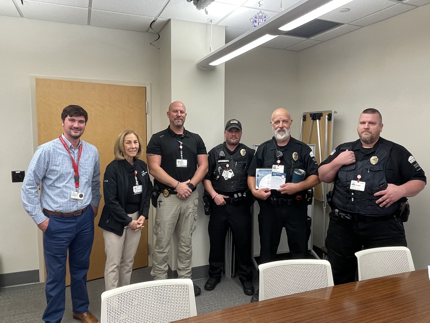Security Officers pose for a picture in a conference room.