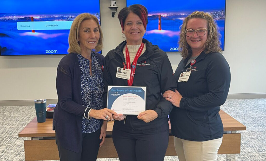 Kathleen Rhine, Angel Marko, and Tara Walker pose for a photo with a certificate