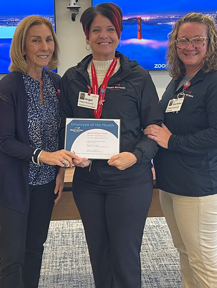 Kathleen Rhine, Angel Marko, and Tara Walker pose for a photo with a certificate