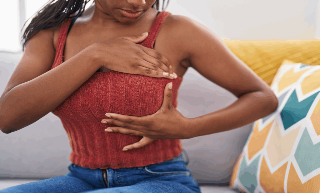 Woman performing breast self-awareness