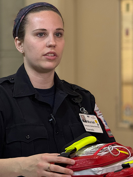 EMS member, Mariah, holds the blood donation cooler