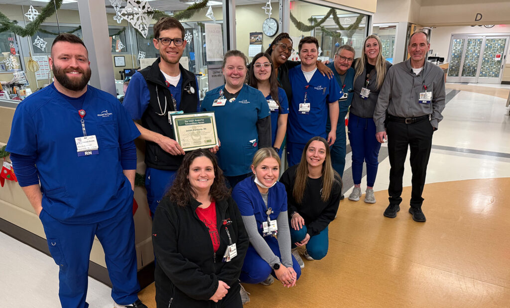 Josiah Contreras, RN poses with is coworkers to celebrate his DAISY Award
