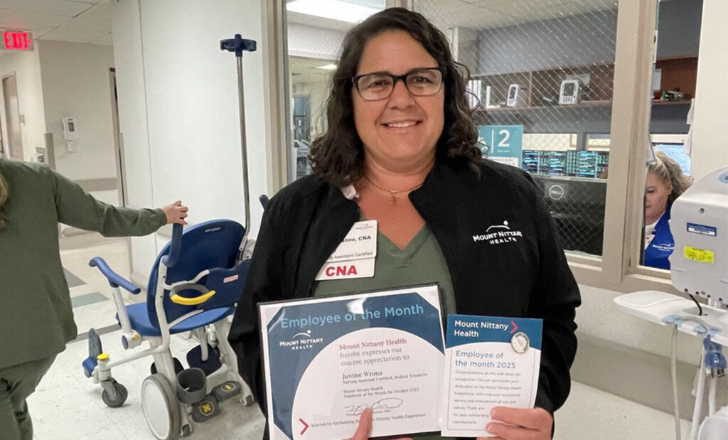 Justine Wrona, CNA poses with her employee of the month certificate