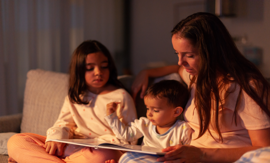 Mom telling a story to her children at night