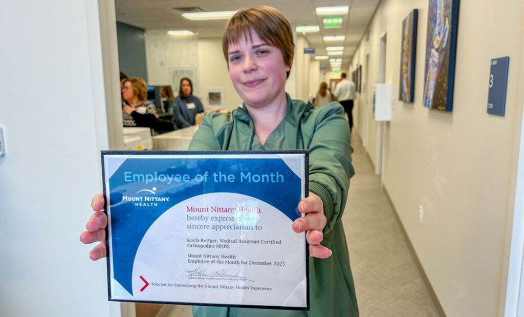 Kayla Rettger poses with her employee of the month certificate