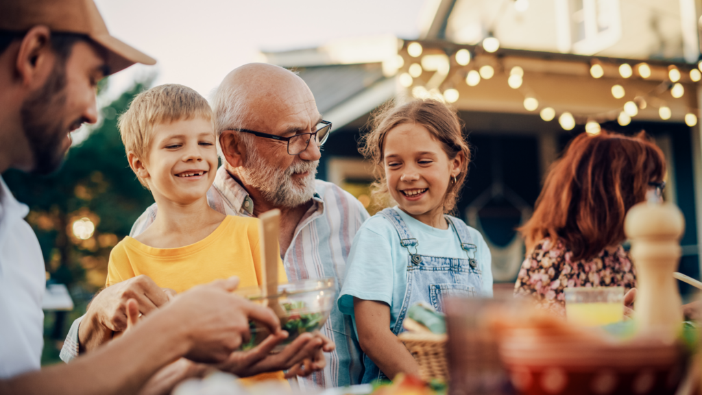 Adults at a Garden Party Together with Children